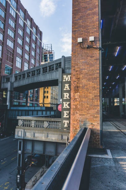 market neon sign seen from high line in chelsea. new york city. the market has lots of stores, restaurants and food markets. - chelsea new york imagens e fotografias de stock