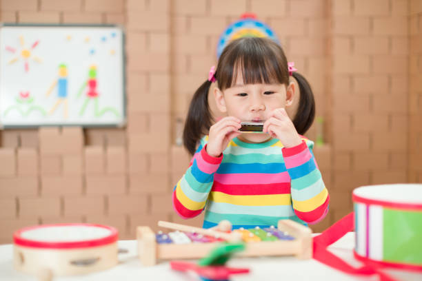istock young girl plays harmonica at home for home schooling 1262792399
