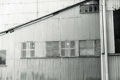 Industrial exterior of abandoned factory, black and white, background with copy space, full frame horizontal composition