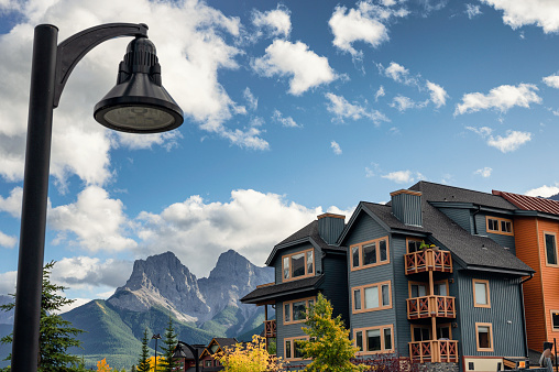 Alberta, Canada - Sep 18 2019 : Wooden buildings with rocky mountains and street light in downtown at Canmore, Canada