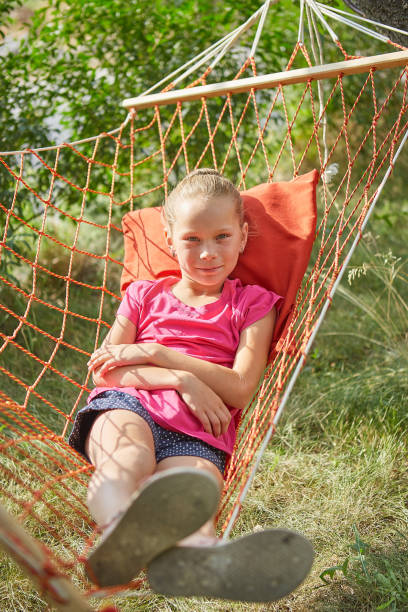 istock Summer vacation - lovely girl in wicker hammock 1262800391