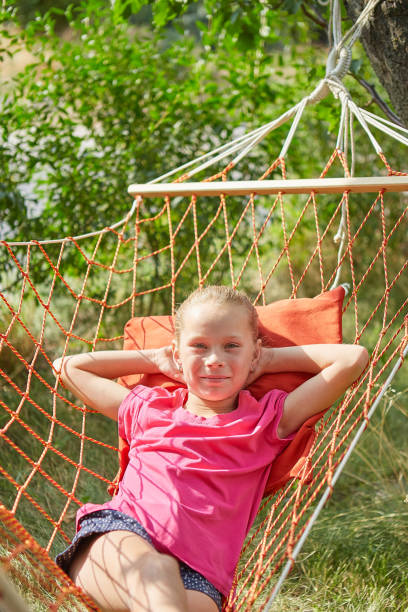 istock Summer vacation - lovely girl in wicker hammock 1262801680