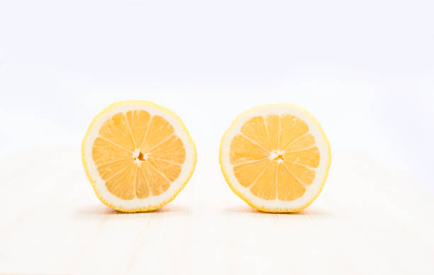 istock Fresh and juicy lemons cut on white background 1262801687