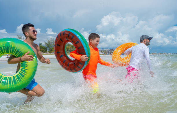 istock Guys with inflatable ring tubes having fun in Florida 1262802264