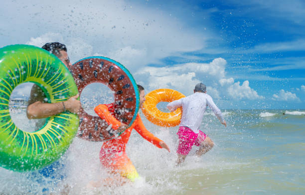 istock Fun with inflatable ring tubes on a beach in Florida 1262802404