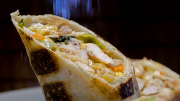 istock Wrapped sandwich with chicken meat, cheese and vegetables 1262812602