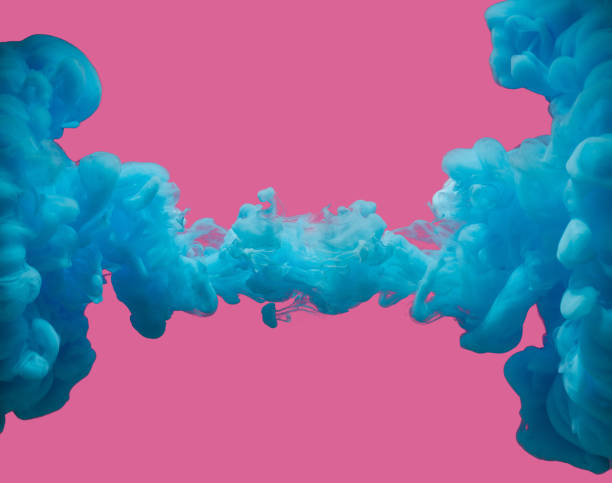 istock Blue paint abstract underwater smoke against pastel pink background 1262816760