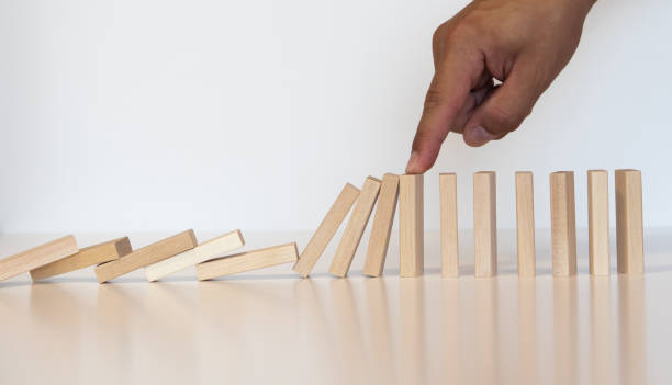 istock Hand of a man playing with dominoes 1262817244