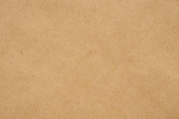istock Brown eco recycled kraft paper sheet texture cardboard background 1262817338
