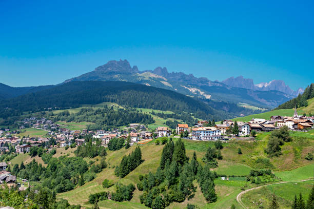 Italy, Dolomites, the Moena village and in the background the Catinaccio mountain Italy, Dolomites, the Moena village and in the background  Catinaccio mountain catinaccio stock pictures, royalty-free photos & images