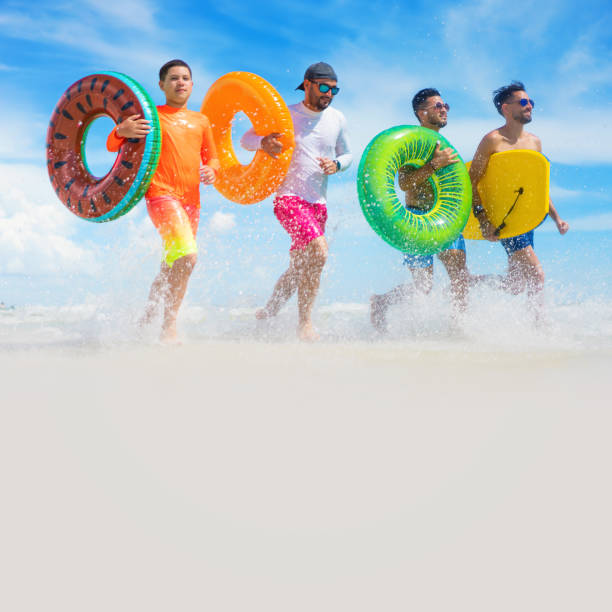 istock Running with inflatable ring tubes on a beach in Miami Beach 1262828685
