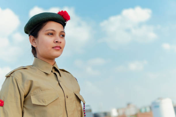 Happy independence day - girl in NCC uniform and looking away. outdoor image of an happy Indian girl in NCC uniform, looking away and celebrating independence day (15 august). indian navy stock pictures, royalty-free photos & images