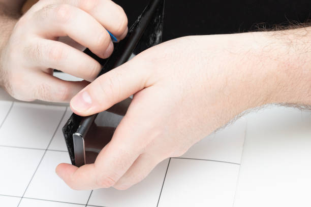 istock Parsing a mobile phone. The wizard opens the cover of the smartphone using special tools 1262836428