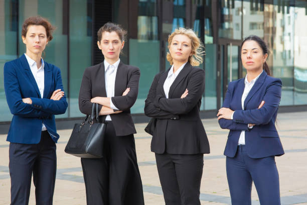istock Serious businesswomen group with arms folded 1262838118