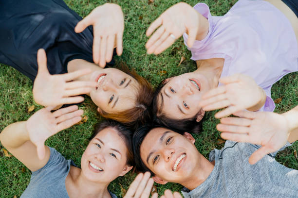 istock Happy young asian lying on the grass 1262845544