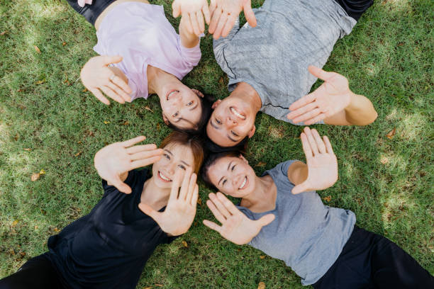 istock Happy young asian lying on the grass 1262845545