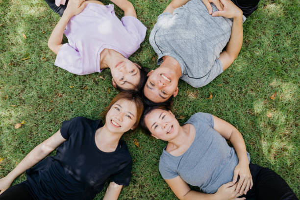 istock Happy young asian lying on the grass 1262845546
