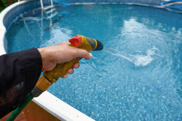 istock hand with a garden hose 1262846271