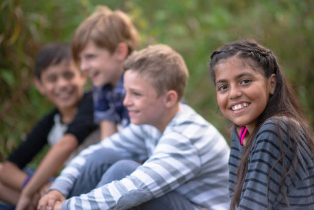 istock Kids laughing together in a natural outdoor setting 1262854860