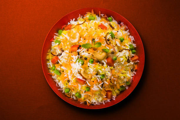 istock Veg biryani or pulav served in a round brass bowl, selective focus in red table 1262858067