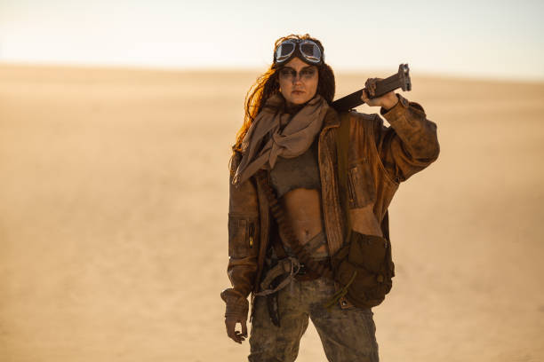 istock Armed Post-apocalyptic Woman Outdoors in a Wasteland 1262860631