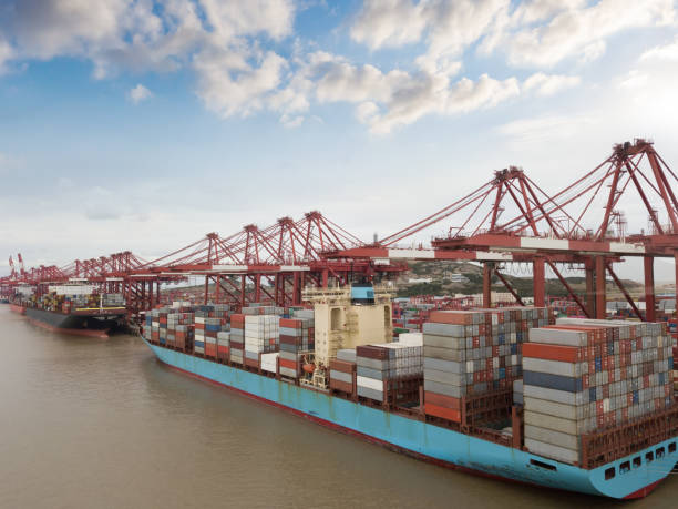 istock Logistics and transportation of Container Cargo ship and Cargo plane with working crane bridge in shipyard 1262869285