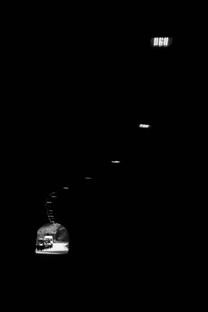 istock car driving through dark modern city tunnel 1262869509