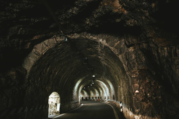 istock car driving through dark modern city tunnel 1262869514