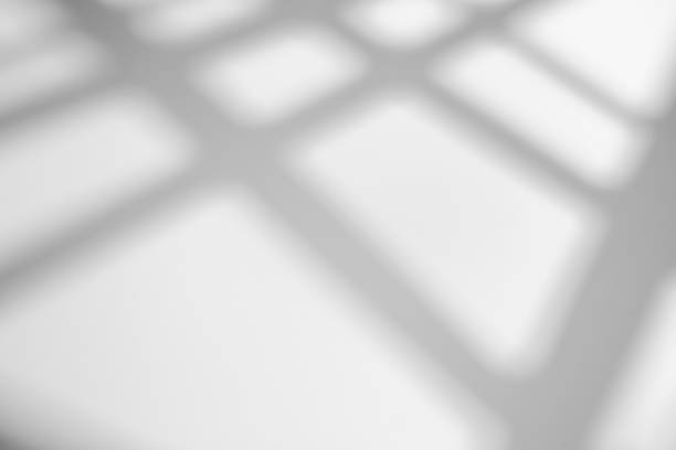 istock The shadow from the window on a white wall in sunny weather with bright light. Shadow overlay effect for photo. 1262875289