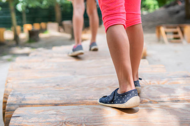 baby feet walking on logs - healthy lifestyle nature sports shoe childhood imagens e fotografias de stock