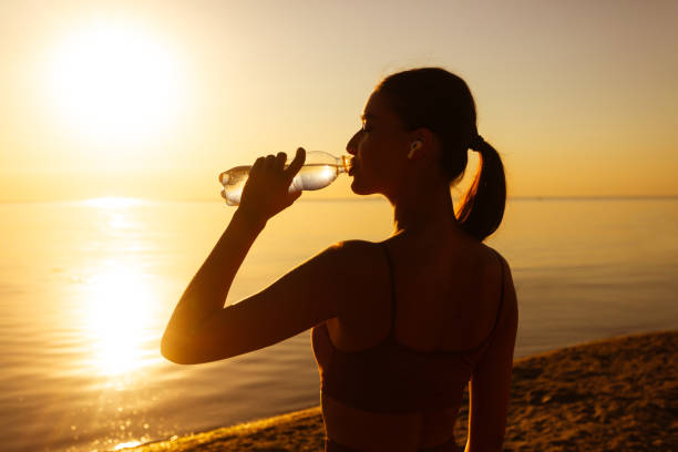 istock Beautiful athlete woman drinking water after work out 1262875422