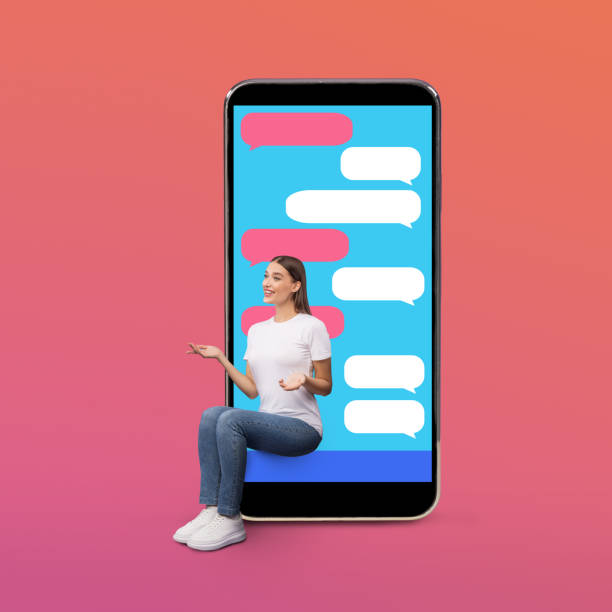 istock Cheerful girl sitting on smart phone screen with sms bubbles 1262875551