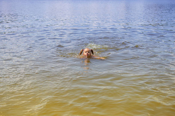 little girl floats down the river from deep to shallow