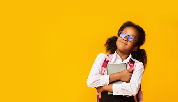 istock Happy African Schoolgirl Hugging Book, Studio Shot, Copy Space 1262877521