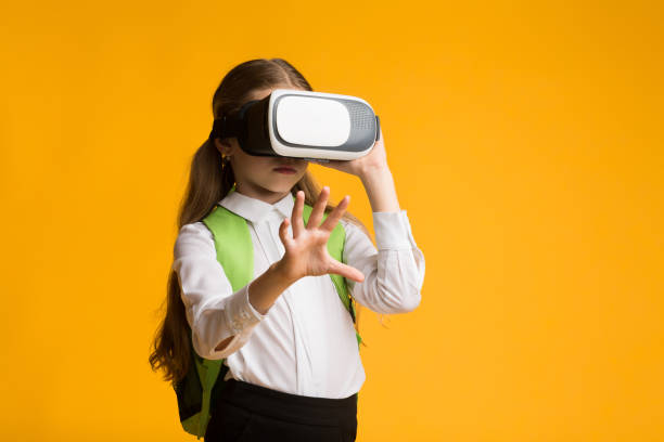 istock Schoolgirl Wearing VR Glasses Experiencing Virtual Reality In Studio 1262878783