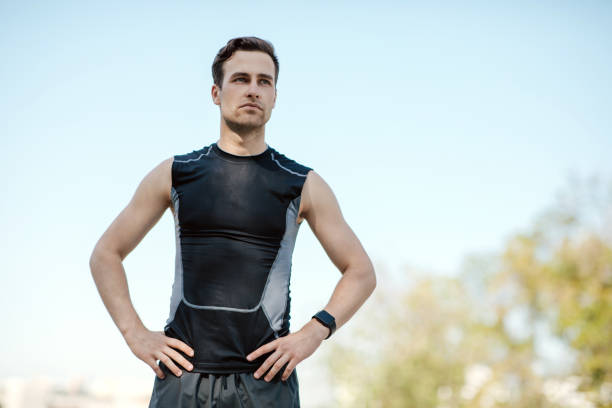 istock Rest during a jog and training to marathon. Guy with smart watch stopped in park 1262878908