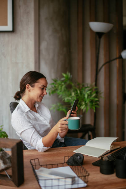 istock Young businesswoman drinking coffee in her office. 1262880157