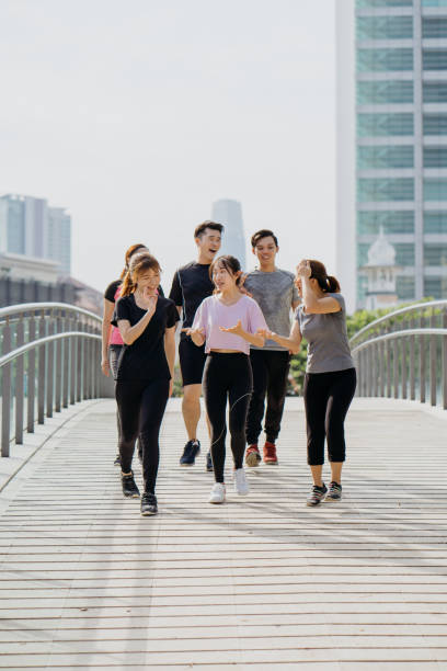 istock Group of young asian jogging through city park 1262880277