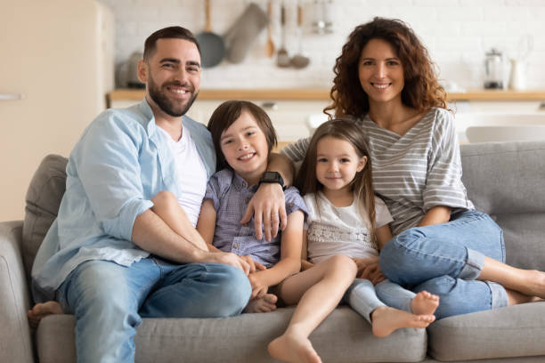 istock Smiling cheerful spouses posing for photo with children. 1262881707
