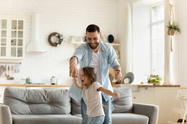 istock Active young father dancing to music with daughter. 1262881743