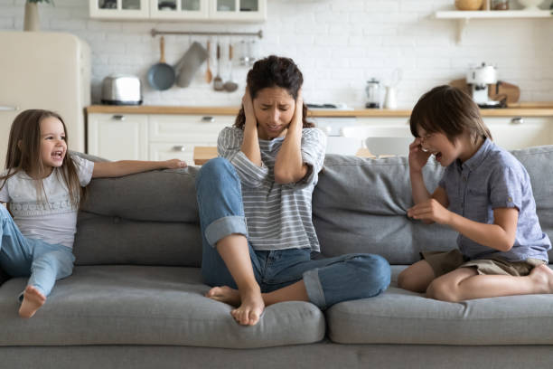 istock Stressed young mommy irritated by bad kids siblings behavior. 1262881746