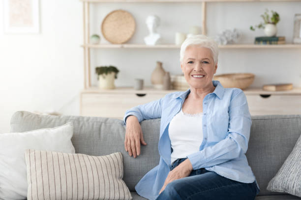 istock Relaxed Elderly Woman Posing On Couch Im Cozy Home Interior 1262883552