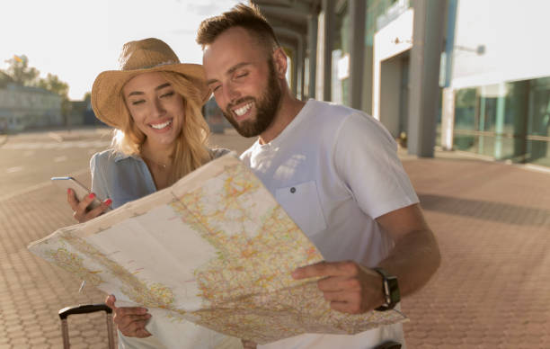 istock Tourists looking at the map and mobile phone 1262883771