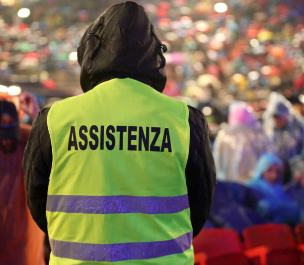 istock boy with high visibility jacket and  text ASSISTENZA that means 1262887110