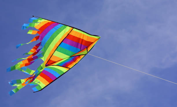 istock colorful kite flies high in the blue sky 1262887606
