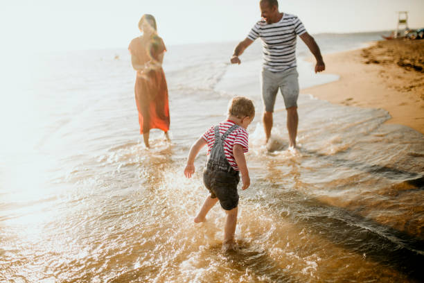 istock Family enjoys the sunset on the beach 1262887627