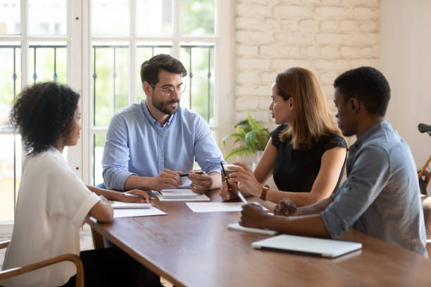 istock Diverse business partners negotiating solving issues gathered together in boardroom 1262889198