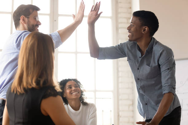 istock African and Caucasian buddies giving high five greeting each other 1262889216