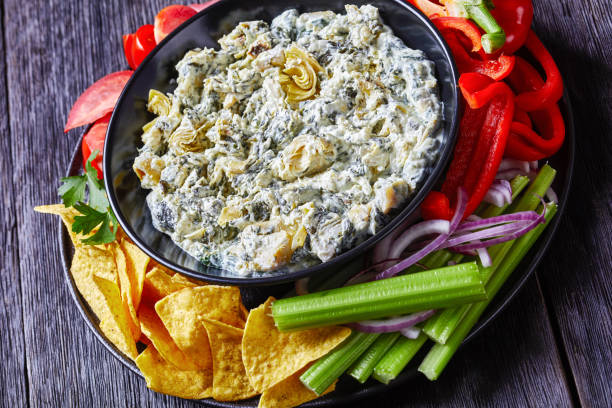 istock Spinach Artichoke leafy cheese Dip in a bowl 1262889791