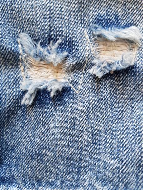istock Torn hole on the worn texture of the jeans 1262889860